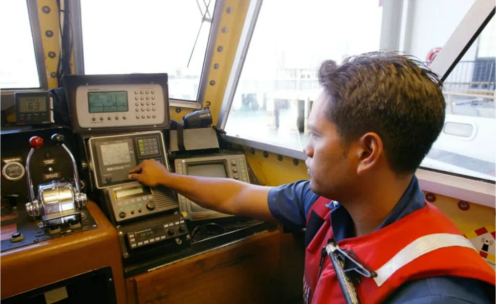 Pat Avelino checks instruments aboard a US Coast Guard vessel prior to a patrol mission.
