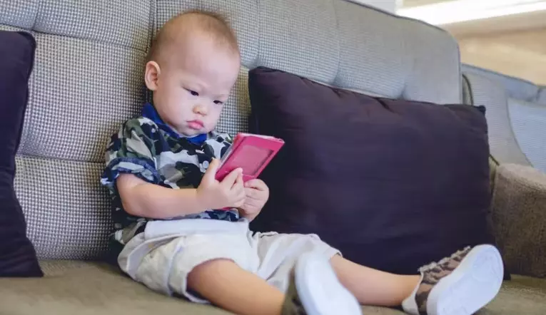 child waching something in mobile device